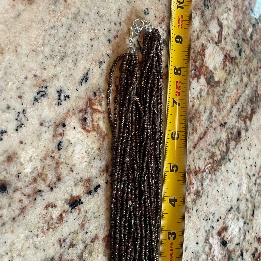 Make a statement with this twisted beaded necklace that has this unique pendant. - Picture 2 of 4